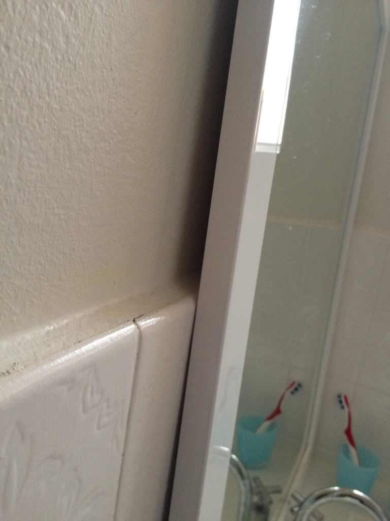 Hanging bathroom mirror on uneven walls